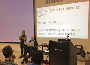 I'm front and centre at Accessibility Toronto Camp 2016, between a sign-language interpreter and the podium, with my laptop on my lap, speaking words on my behalf.