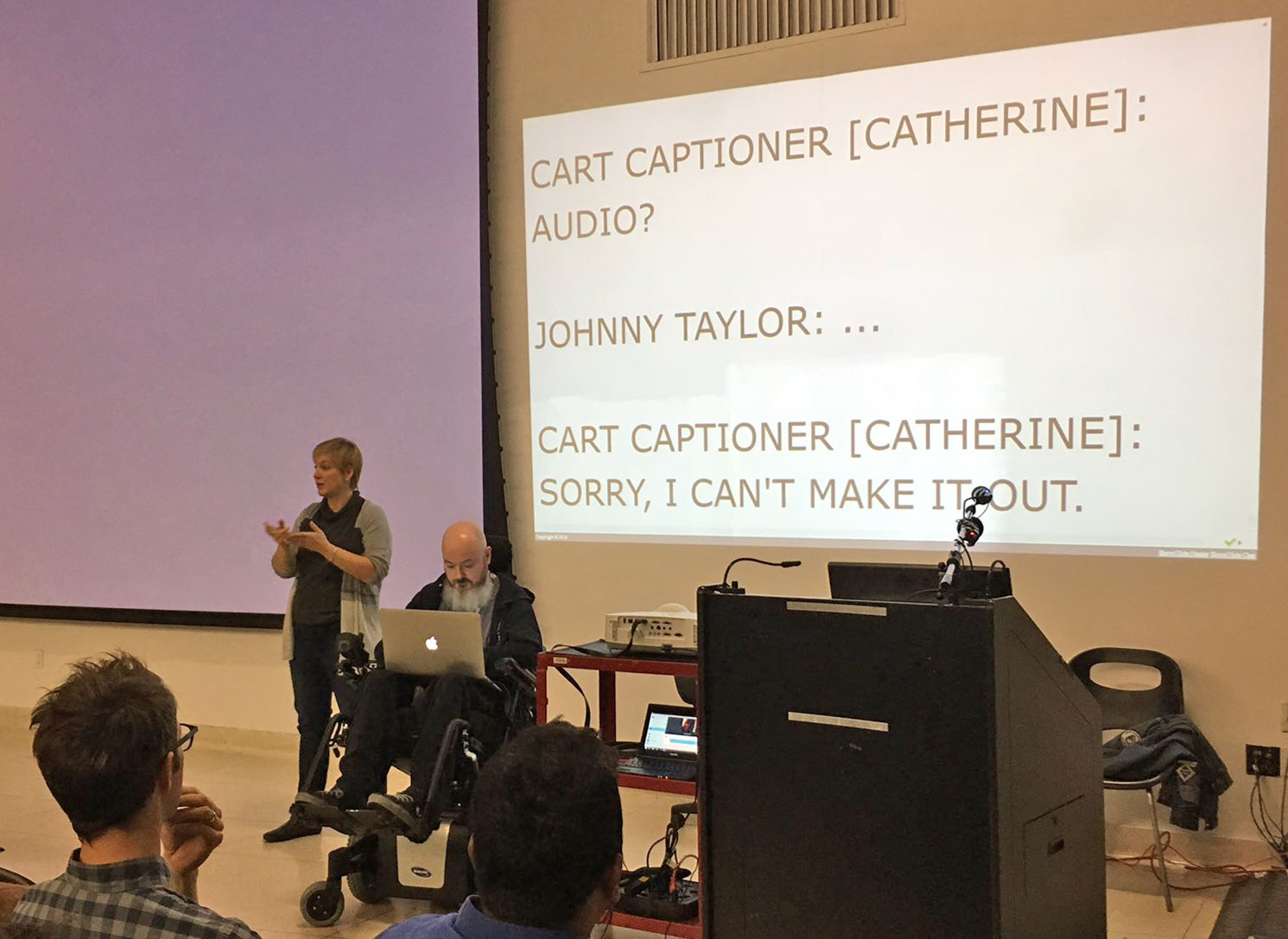 I'm front and centre at Accessibility Toronto Camp 2016, between a sign-language interpreter and the podium, with my laptop on my lap, speaking words on my behalf.